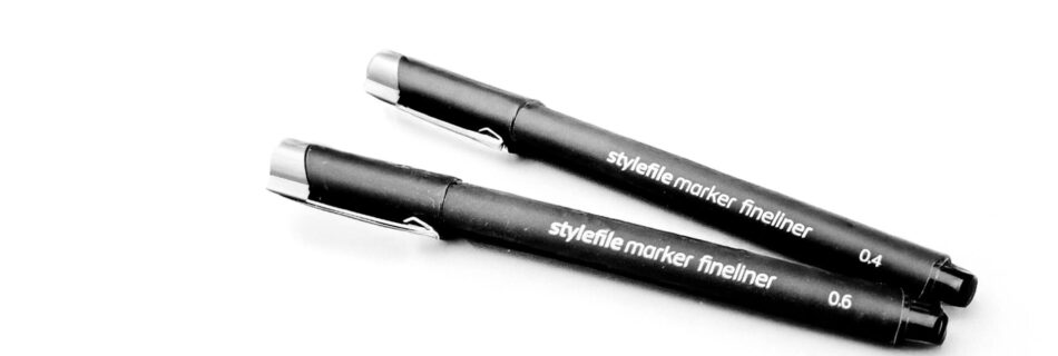 An edited photo of two black markers on white paper.