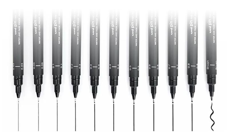 Eleven markers with a ink trail coming out of them in paper.